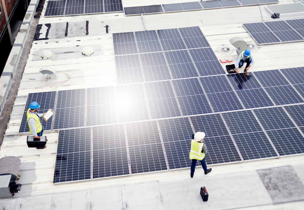 Solar energy, construction and employees building solar panels in collaboration for sustainability