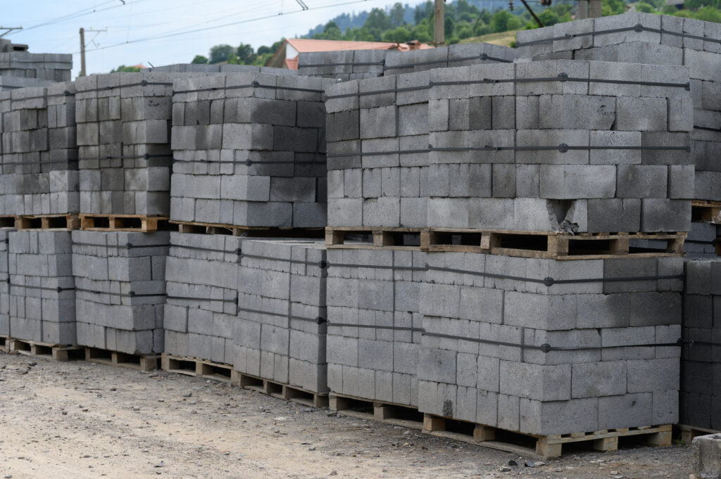 White brick for construction. Cinder blocks stacked on pallets.